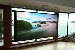 A projector screen floating in front of a window