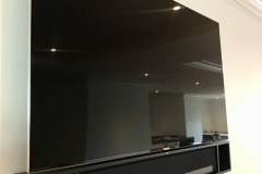a wall mounted tv with a sonos sound bar