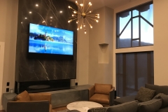 A tv mounted over a fireplace with a sound bar