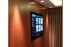 A recessed wall mounted tv with a soundbar