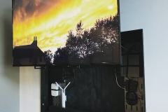 a wall mounted tv with av behind it